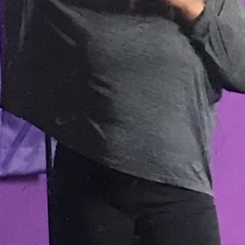 grey top with long sleeves.